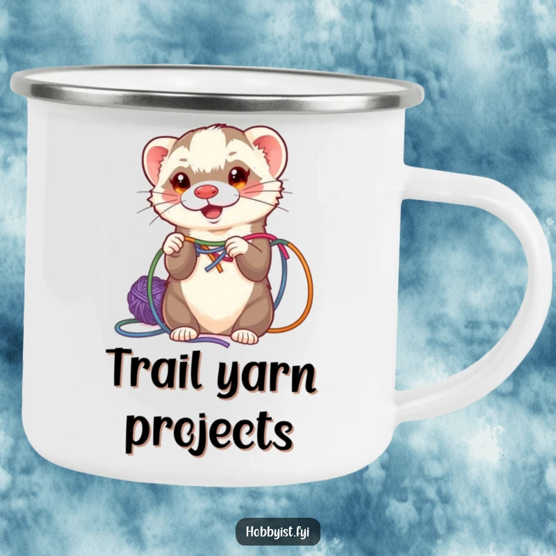 Funny ferret weaving colorful yarn, on a sturdy enamel camping mug, perfect for outdoor crafting sessions.