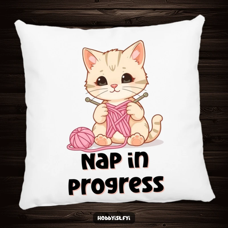 Funny decorative pillow featuring a curious cat with knitting needles and yarn, a ball of wool bouncing, ideal for cozy crafting spaces.