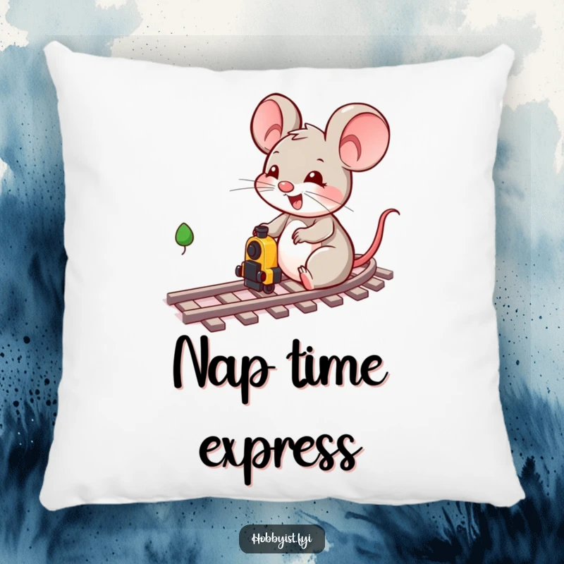 Funny cheerful mouse character engrossed in playing with miniature train tracks and a small train on a soft, decorative pillow.