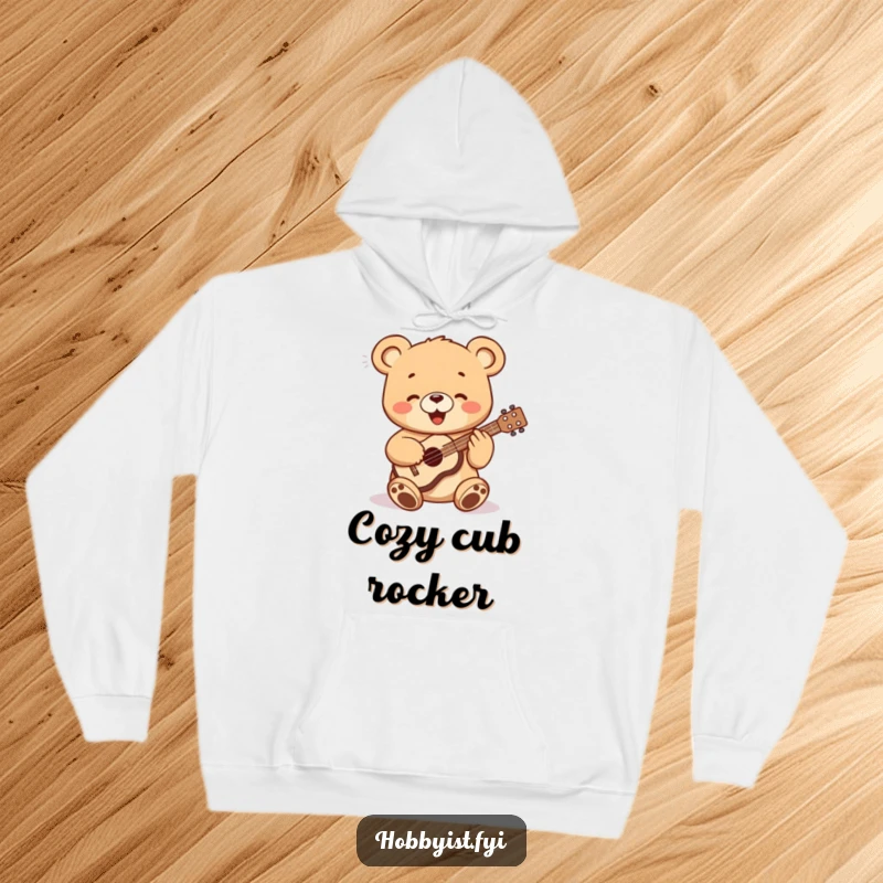 Funny, happy bear cub playing a tiny ukulele, depicted on a comfortable hooded sweatshirt, a delightful gift for all.