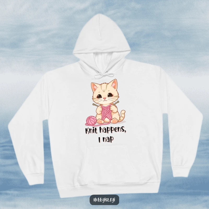 Cozy hooded sweatshirt featuring a curious cat with knitting needles and yarn, a ball of wool bouncing, perfect for knitters and cat lovers.