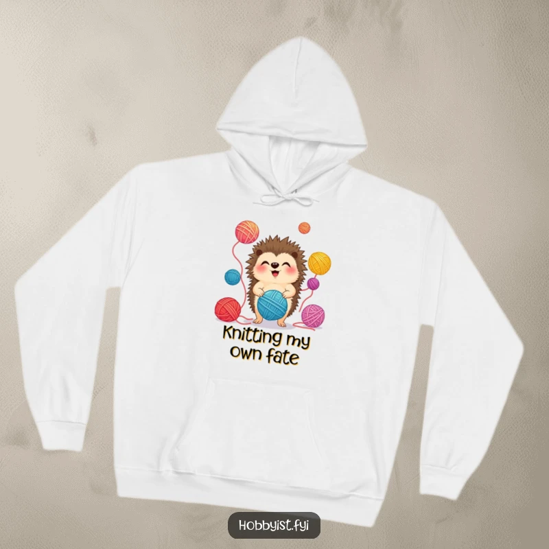 Funny Hoodie showcasing a giggling hedgehog juggling colorful yarn balls, exuding warmth and playful energy.