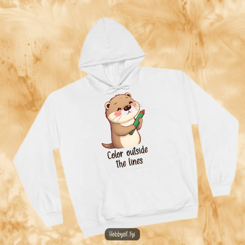 Funny Hoodie showcasing a playful otter sketching a whimsical portrait with a large crayon, exuding fun and creativity.