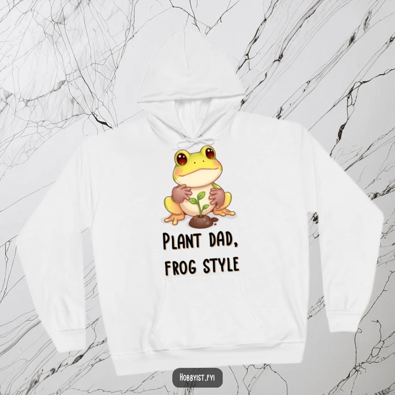 Funny Frog Hoodie: A playful frog with tiny gardening gloves tends to a miniature sprout, offering warmth and gardening charm, a fantastic funny gift.