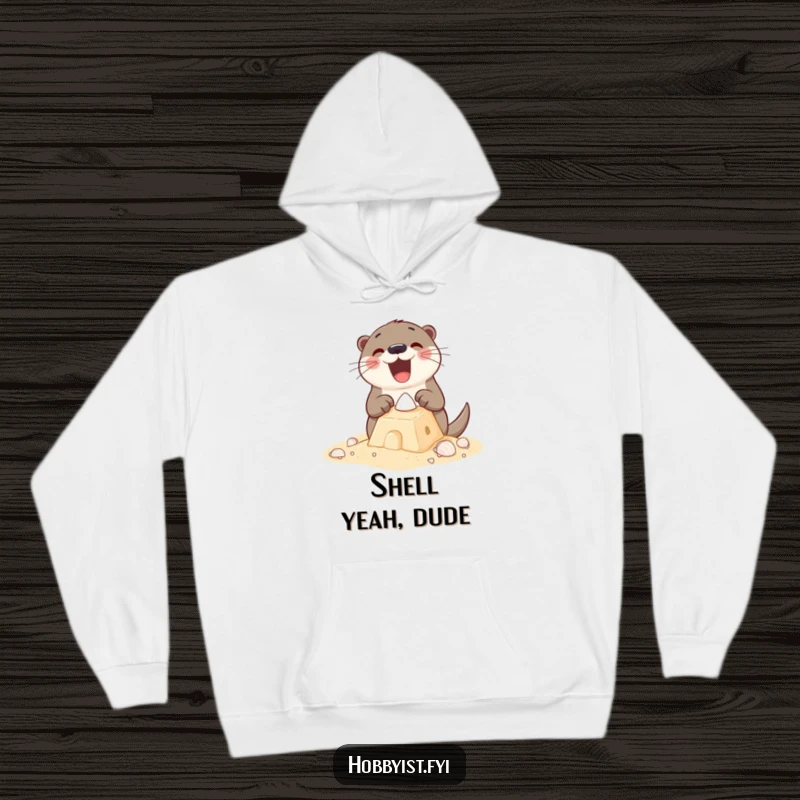 Funny Hoodie featuring an excited otter building a sandcastle with tiny shells, perfect for staying warm while channeling beach vibes.
