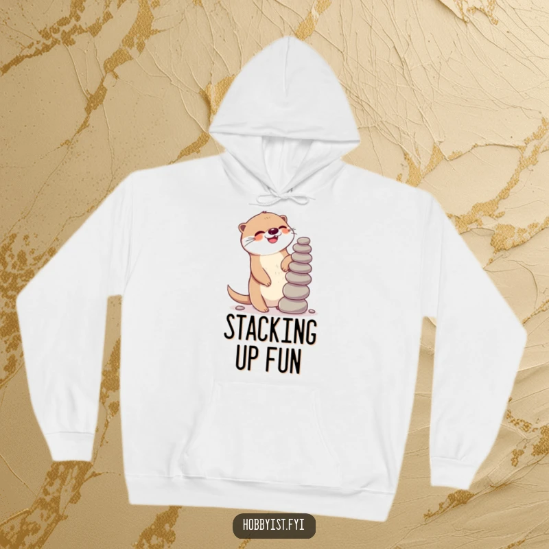 Funny Kawaii otter hoodie, depicting a giggling otter gleefully balancing a precarious stack of pebbles, perfect for cozy relaxation.