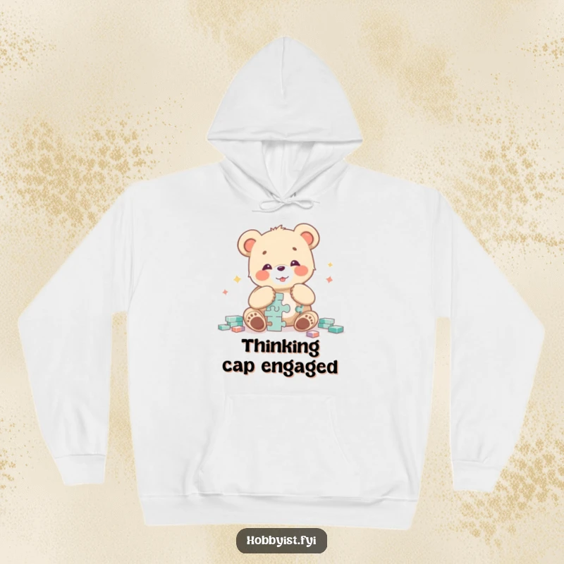 Funny bear cub character radiating joy while piecing together a challenging puzzle, depicted on a warm and cozy hoodie.