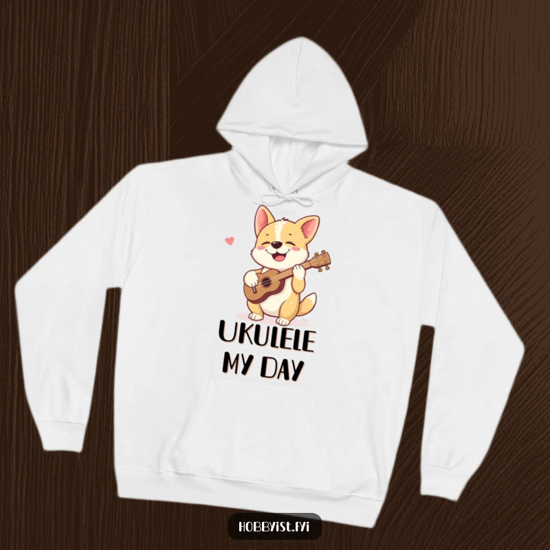 Funny hoodie featuring a giggling dog happily strumming a tiny ukulele, perfect for cozy wear and humorous musical vibes.