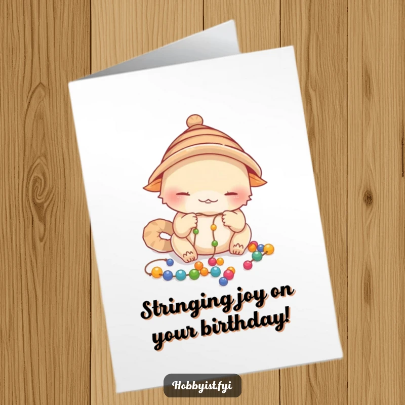 Funny Free Printable Birthday Card: A creature in a small hat carefully beading colorful threads.