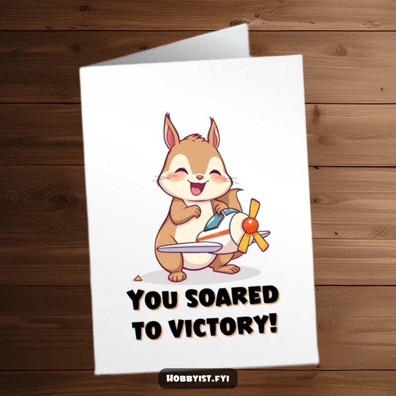 Funny Free Printable Congratulations Card: Happy kawaii squirrel character proudly completing a miniature model airplane, celebrating a win.