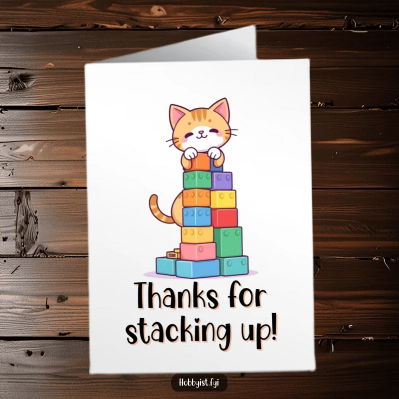 Funny Free Printable Thank You Card: A focused cat carefully builds a tall tower of colorful building blocks, showing dedication.