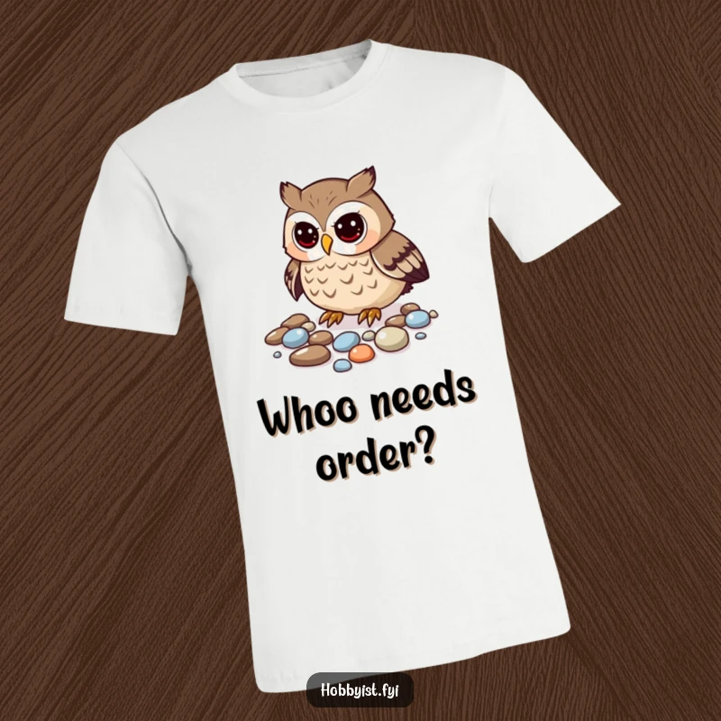 Funny owl t-shirt of a curious owl carefully organizing a heap of shimmering pebbles, a collector's delight.